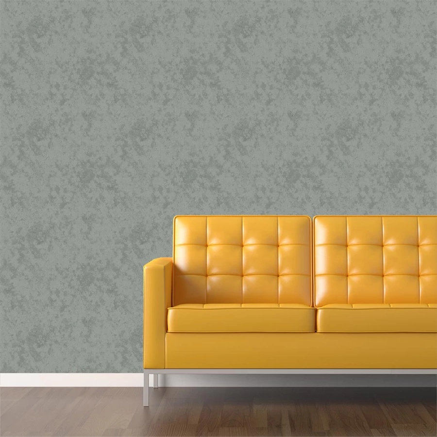 Sárga bőrkanapé egy szürke fal előtt, modern belső térben.